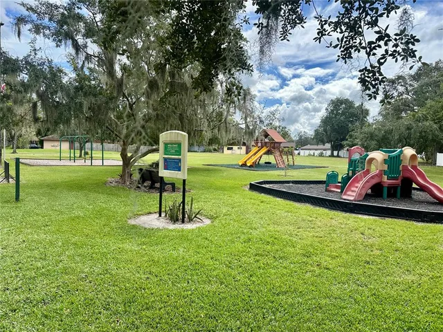 a childrens park with lots of swings and slides