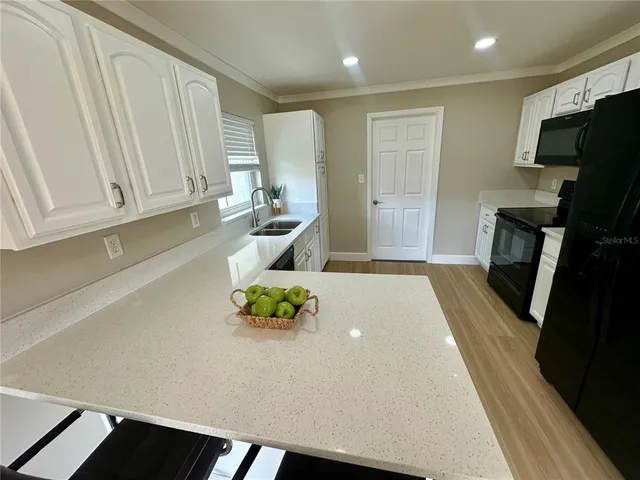 a view of kitchen with furniture and wooden floor
