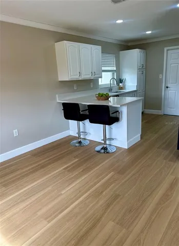 a kitchen with stainless steel appliances kitchen island sink refrigerator and cabinets