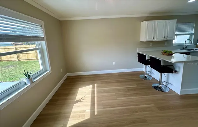 a room with wooden floor and a window