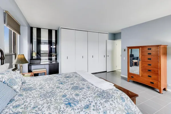 a bedroom with a bed and a dresser