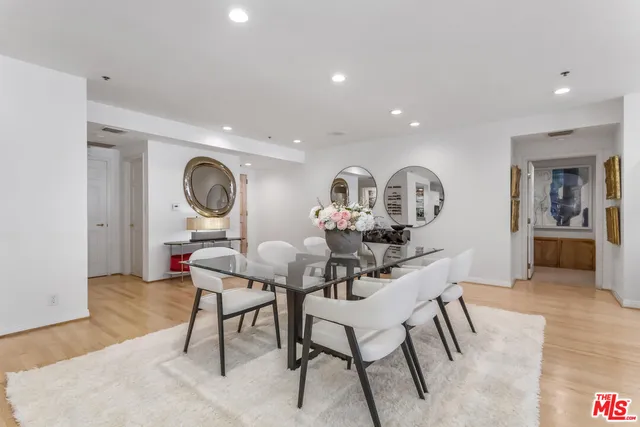 a living room with dining room and wooden floor