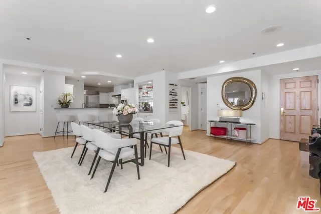 a living room with furniture a clock and a large window