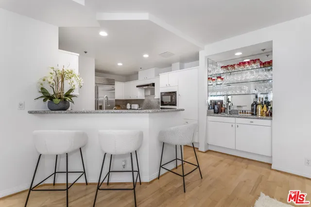 a kitchen with stainless steel appliances kitchen island granite countertop a sink and cabinets