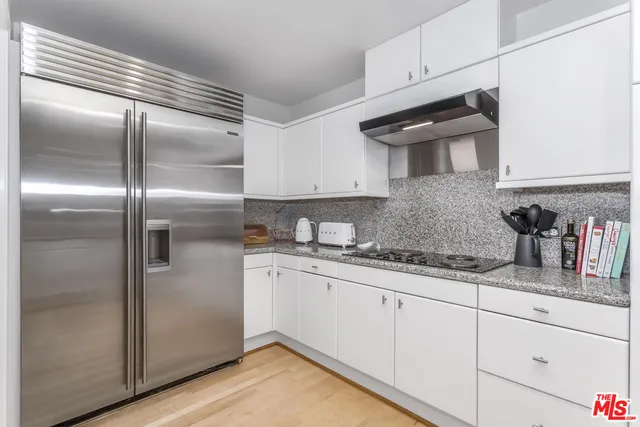 a kitchen with granite countertop stainless steel appliances and sink