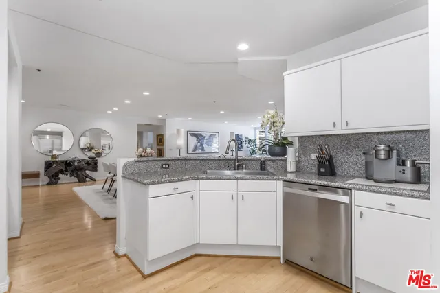 a kitchen with sink and cabinets