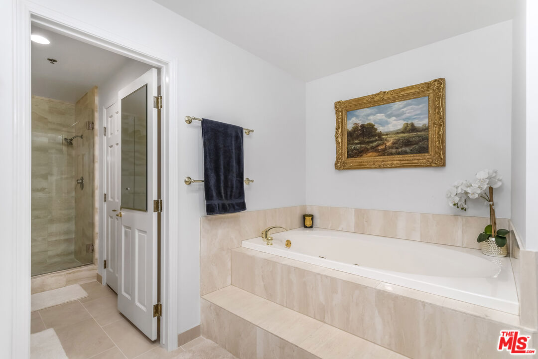 10724 Wilshire Boulevard, Unit 1005 Los Angeles, CA 90024 - Photo 27 of 45 a white bath tub sitting next to a white sink