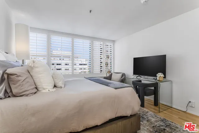 a bedroom with a bed and a television