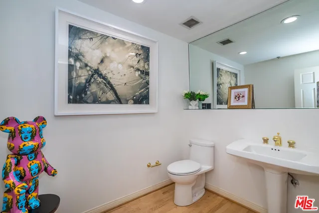 a bathroom with a sink a vanity and a toilet