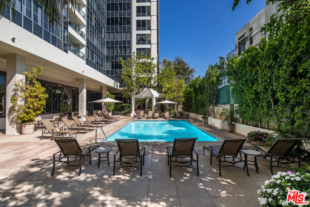 10724 Wilshire Boulevard, Unit 1005 Los Angeles, CA 90024 - Photo 38 of 45 a view of a patio with table and chairs and potted plants