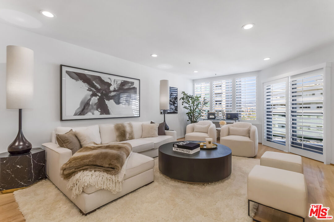 10724 Wilshire Boulevard, Unit 1005 Los Angeles, CA 90024 - Photo 6 of 45 a living room with furniture and a large window