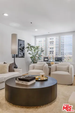 a living room with furniture and large windows