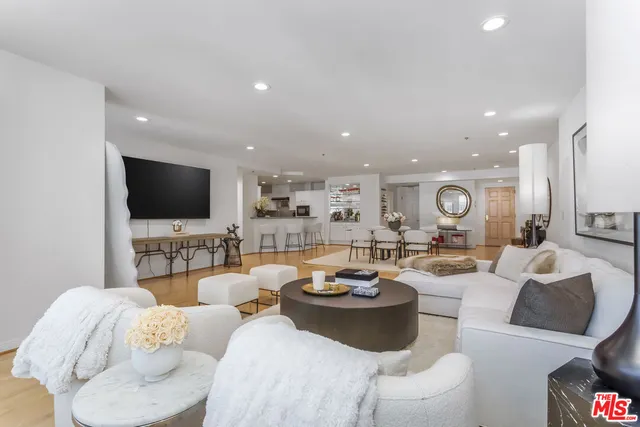 a living room with furniture a flat screen tv and white floor
