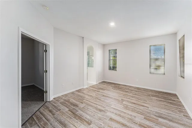 a view of empty room with wooden floor