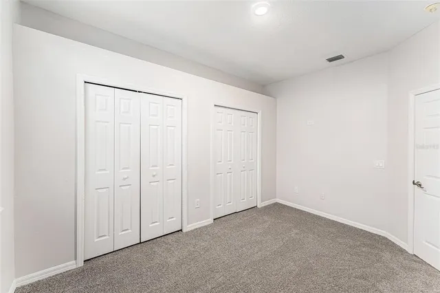 an empty room with closet area