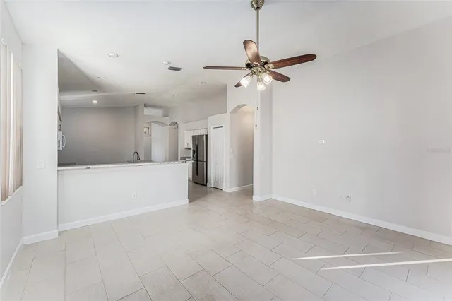 a view of a kitchen with a refrigerator and a ceiling fan