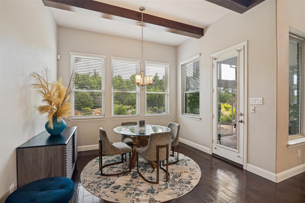 388 Bethany Road Sunnyvale, TX 75182 - Photo 15 of 40 Bright dining area featuring dark wood-finish flooring, a full-light exterior door, and a multi-light chandelier