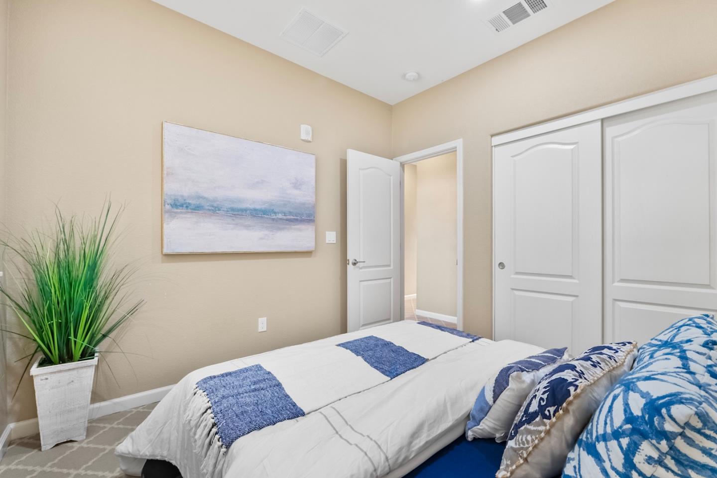 1306 Thistle Place Milpitas, CA 95035 - Photo 31 of 43 a bedroom with a large bed and a potted plant