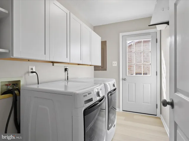 a kitchen with stainless steel appliances granite countertop a sink and a refrigerator