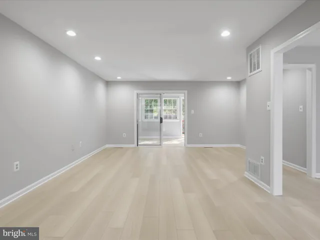 an empty room with windows and closet