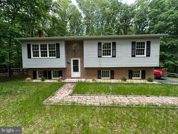 a front view of a house with a yard and porch