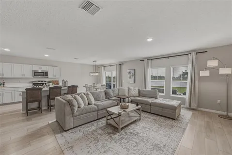 a living room with furniture window and wooden floor
