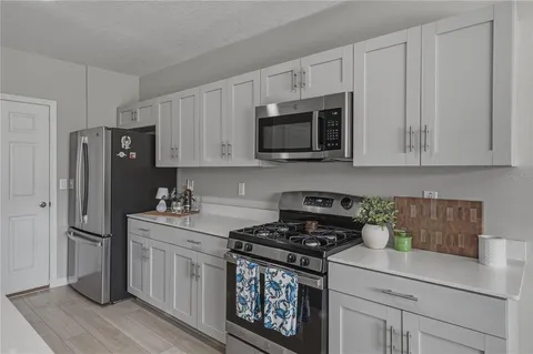 a kitchen with cabinets and stainless steel appliances