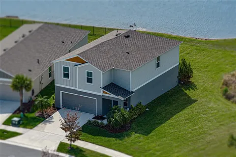 a aerial view of a house with a yard patio and swimming pool