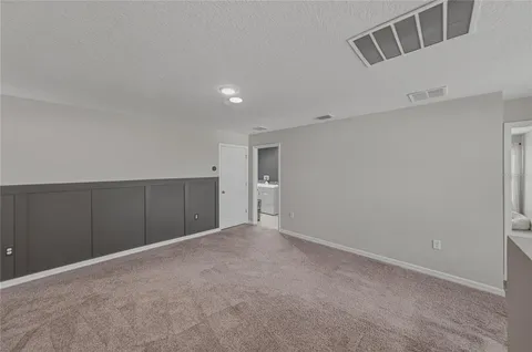 a view of walk in closet with clothes