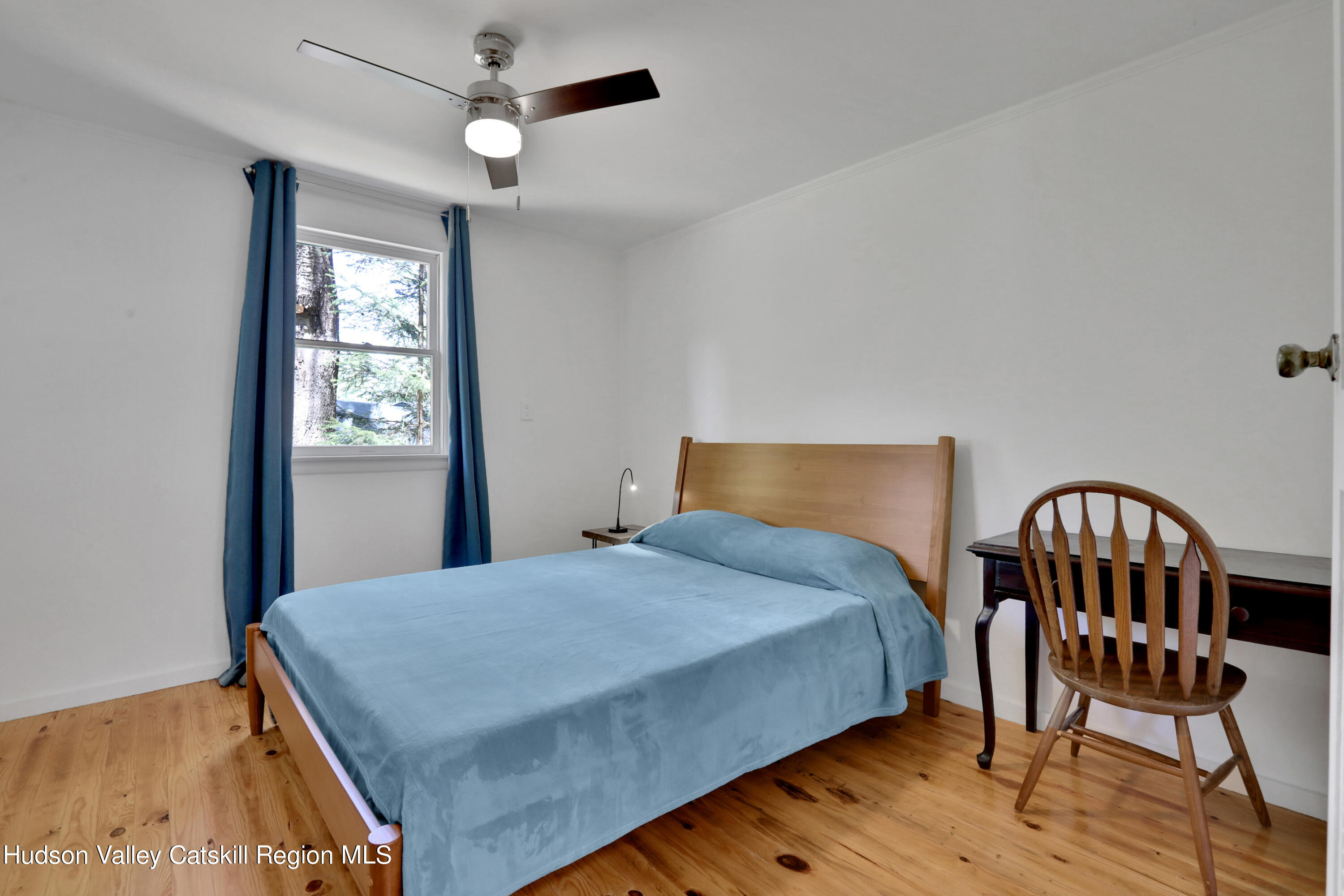 26 Beach Road Lumberland, NY 12737 - Photo 13 of 22 a bedroom with a bed a dresser and wooden floor