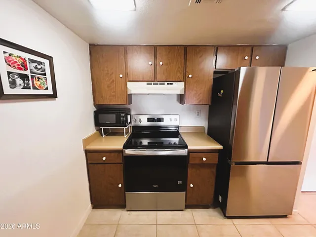 a stove top oven sitting inside of a kitchen