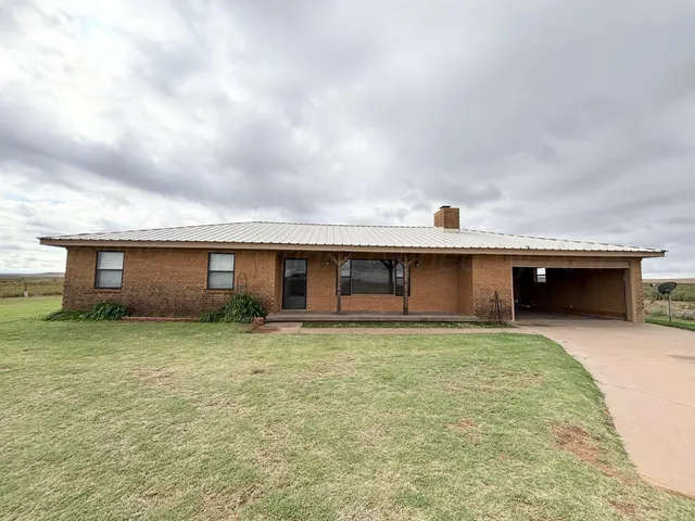 a view of a house with a yard and garage