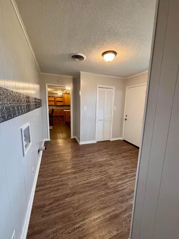 a view of a hallway with wooden floor