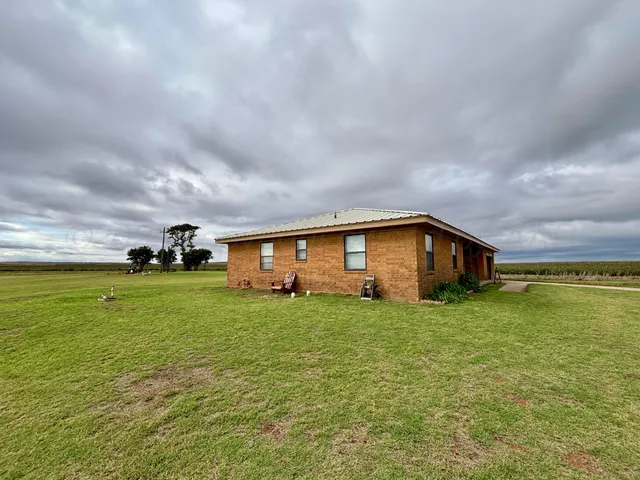 a big house with a big yard and large trees