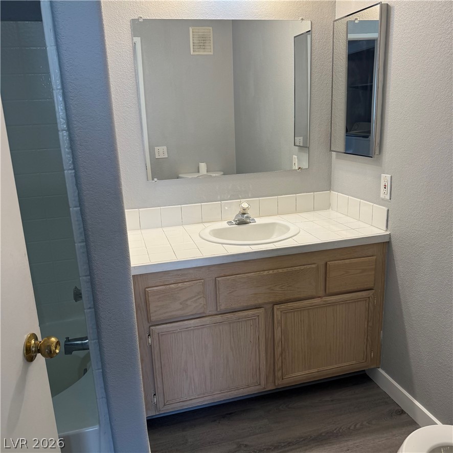 1830 North Pecos Road, Unit 258 Las Vegas, NV 89115 - Photo 10 of 14 A classic tiled vanity with a well-maintained sink anchors this functional bathroom.