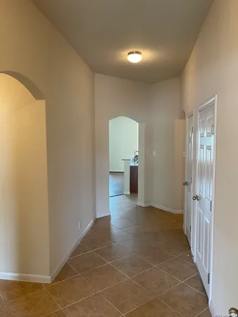 a view of a room with an empty space and a hallway