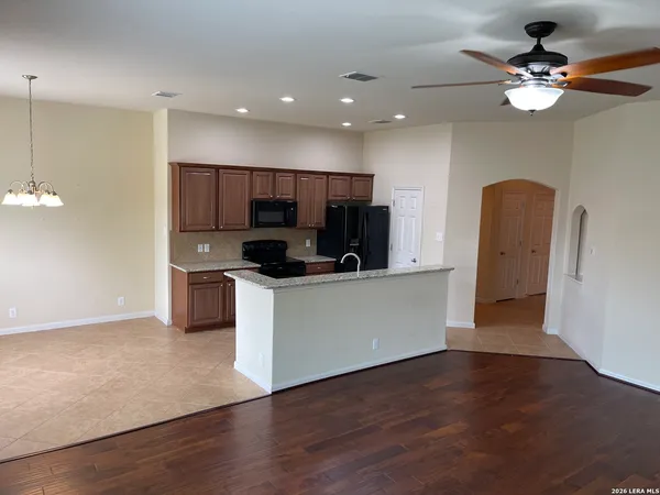 a view of kitchen with stainless steel appliances refrigerator stove microwave and cabinets