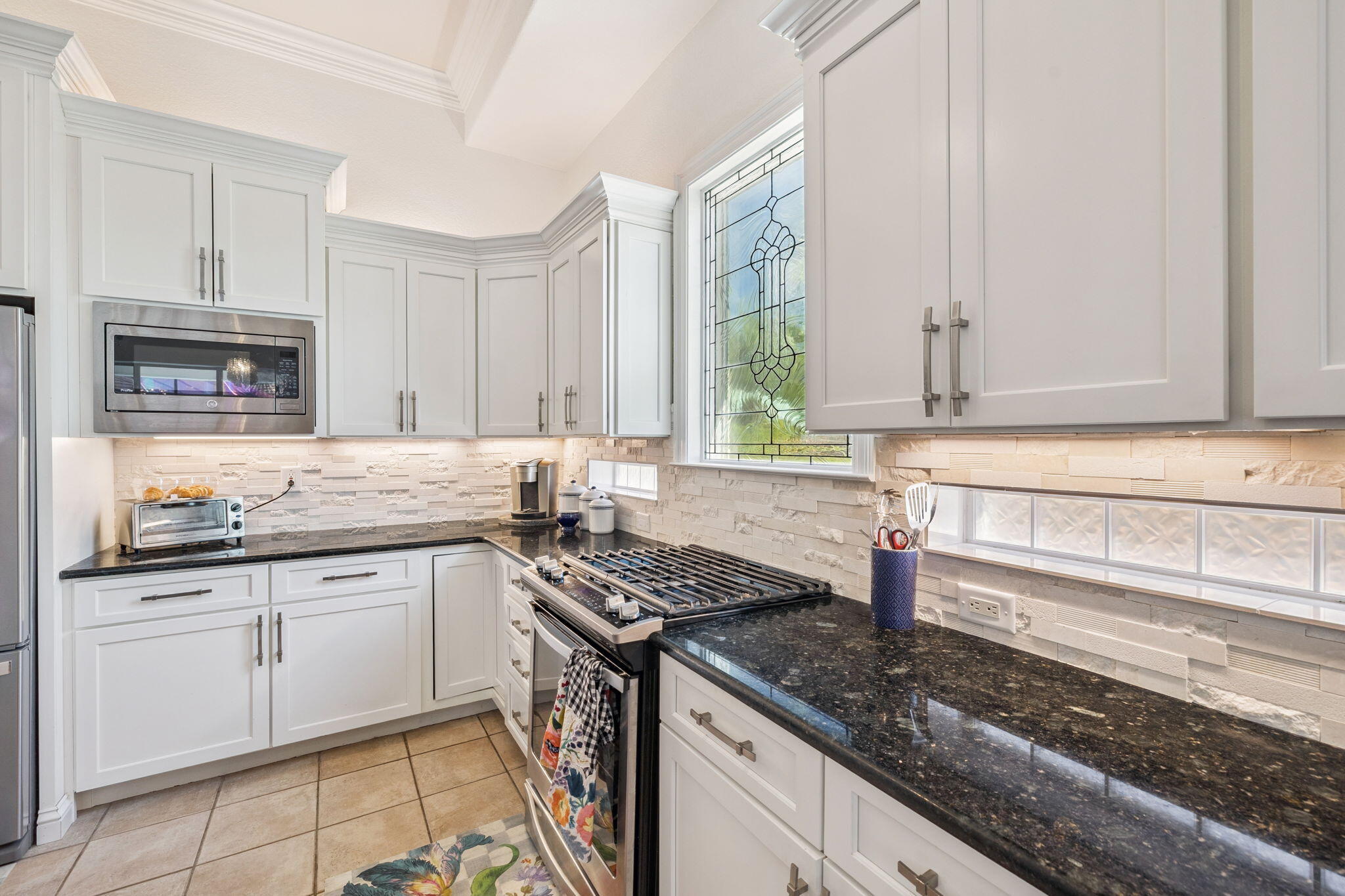4732 Papaya Park Destin, FL 32541 - Photo 4 of 50 a kitchen with granite countertop a sink stainless steel appliances white cabinets and a window