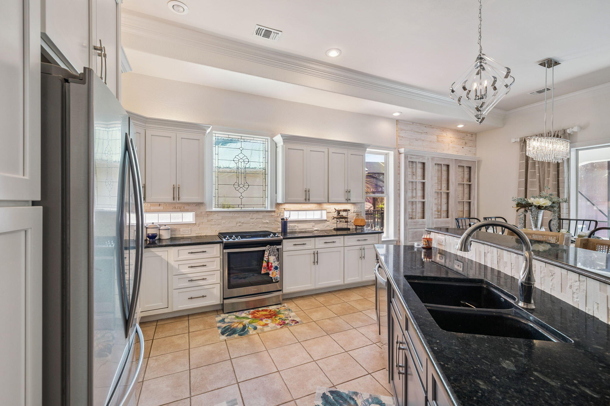 4732 Papaya Park Destin, FL 32541 - Photo 5 of 50 a kitchen with granite countertop cabinets a stove a sink and a dining table