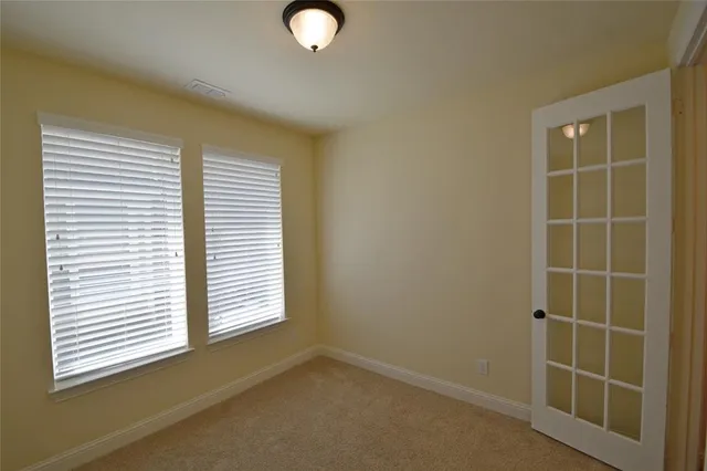an empty room with closet and mirror