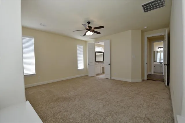 a bathroom with a granite countertop sink a mirror and shower