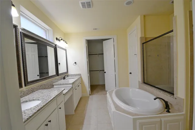 en empty room with windows and chandelier fan