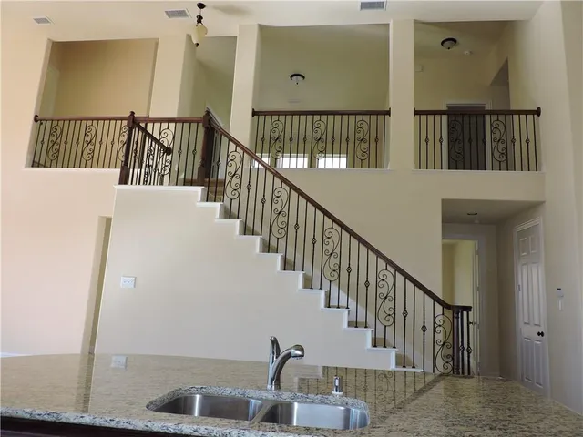 a large kitchen with stainless steel appliances granite countertop a sink a stove and a wooden floors