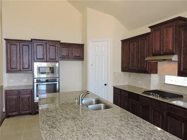 a view of staircase with lots of frames on wall and windows