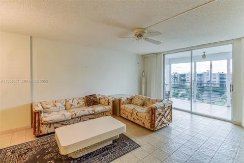 a living room with furniture and a floor to ceiling window
