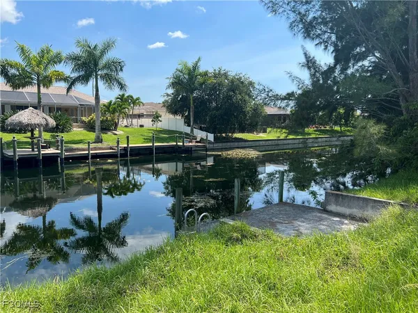a view of a lake with a yard and a fountain