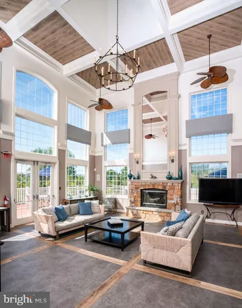a living room with furniture fireplace and a chandelier