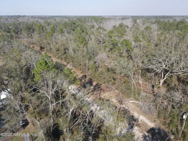 a view of a field with trees in the background