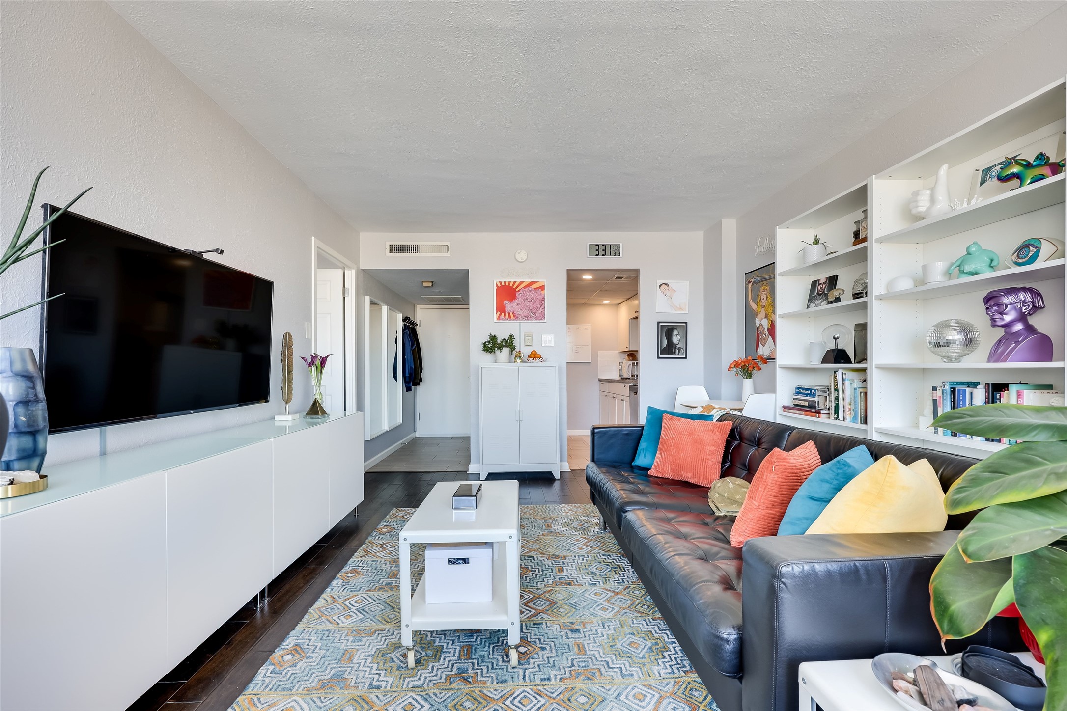 1800 Lavaca Street, Unit A711 Austin, TX 78701 - Photo 4 of 18 a living room with furniture and a flat screen tv
