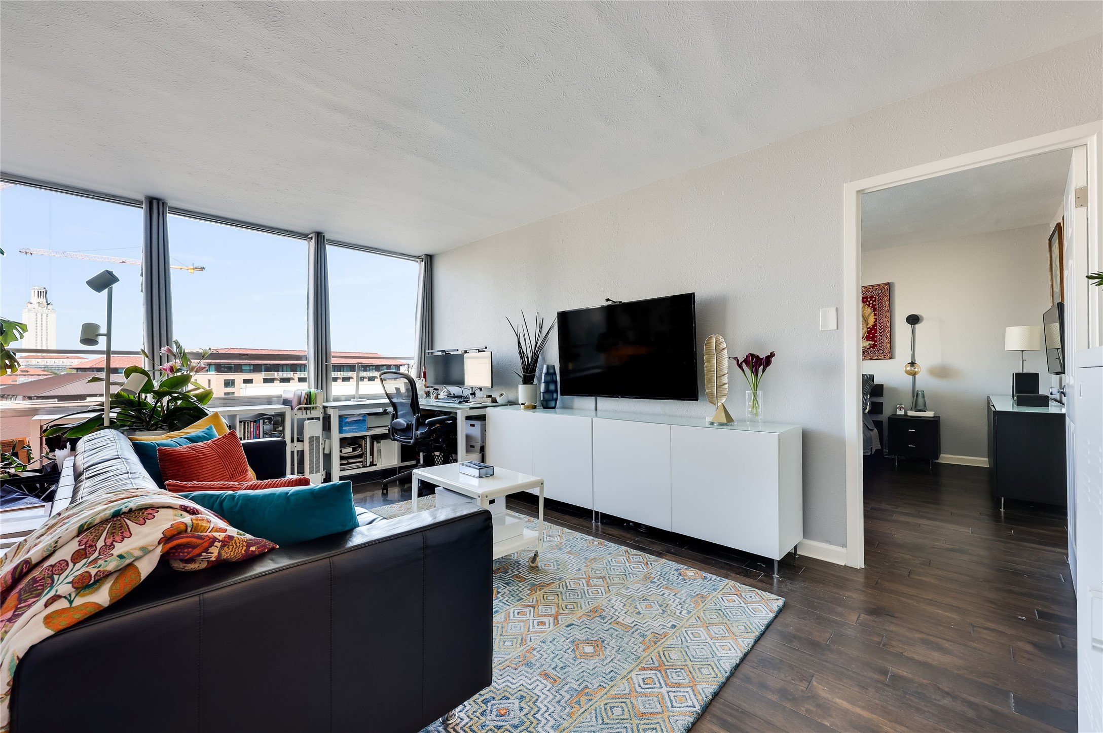 1800 Lavaca Street, Unit A711 Austin, TX 78701 - Photo 5 of 18 a living room with furniture and a flat screen tv